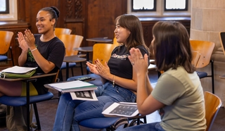 Three students sitting in classroom